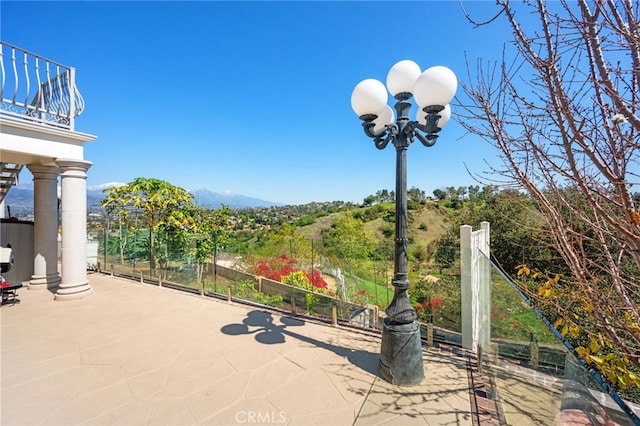 view of patio featuring a balcony
