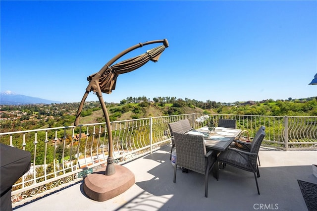 view of patio featuring a balcony and outdoor dining area
