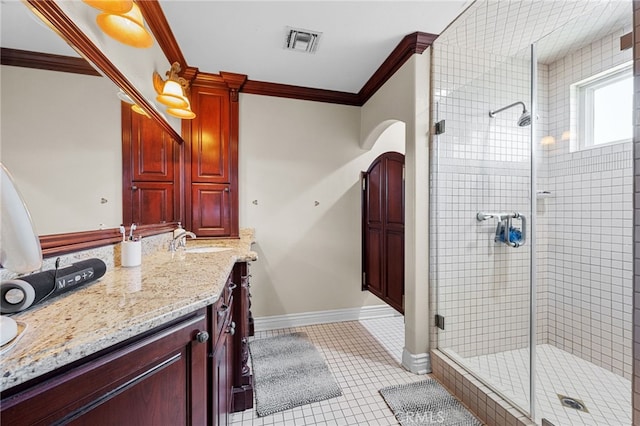 bathroom featuring ornamental molding, visible vents, a shower stall, and vanity