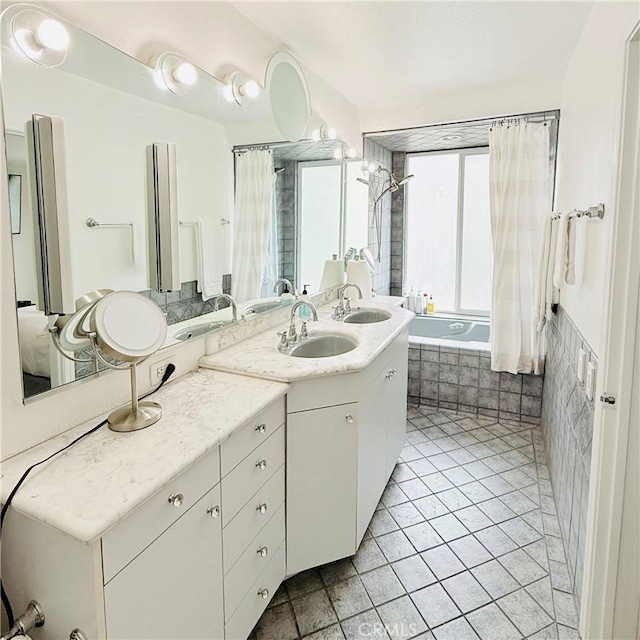 bathroom featuring vanity, tile patterned floors, and tiled shower / bath combo