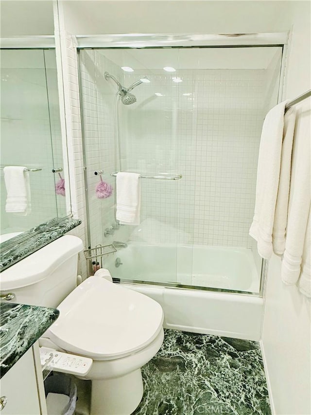 full bathroom with vanity, toilet, and bath / shower combo with glass door