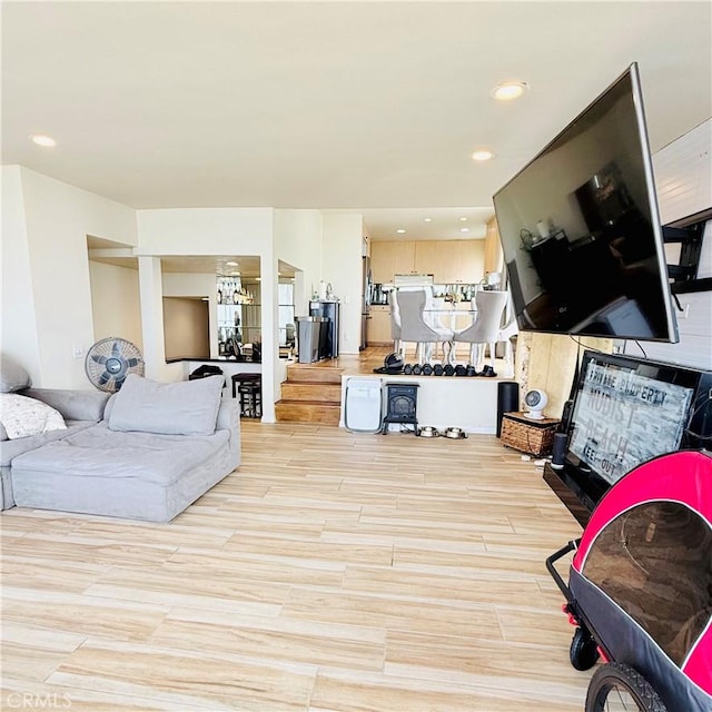 living area with recessed lighting and light wood-style floors