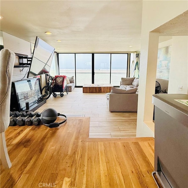 living area featuring a wall of windows and wood finished floors