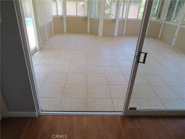unfurnished sunroom with a wealth of natural light