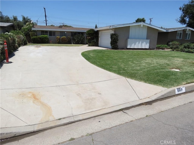 single story home featuring stucco siding, an attached garage, concrete driveway, and a front lawn