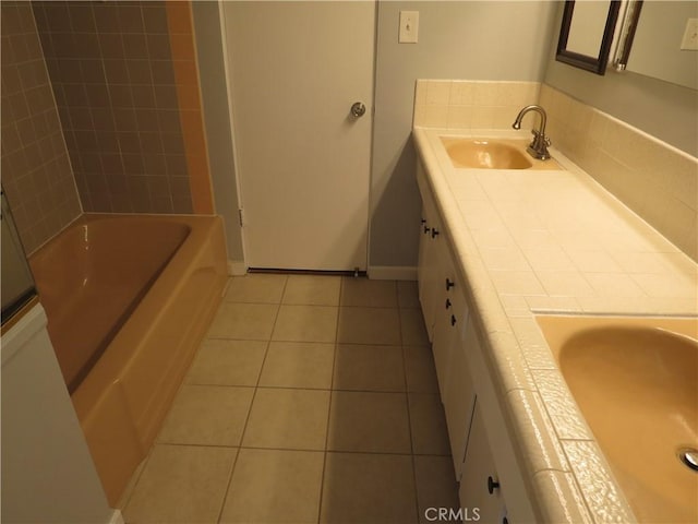 full bath with tile patterned floors, vanity, and baseboards
