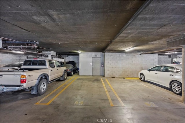 parking deck featuring concrete block wall