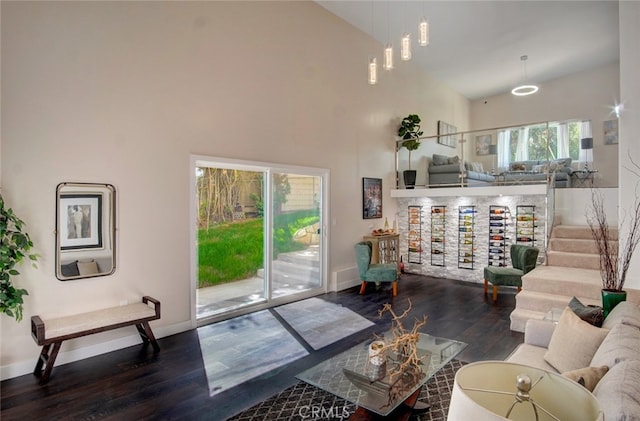 21655 Temescal Canyon Rd, Corona, CA 92883 - living area featuring high vaulted ceiling, baseboards, and wood finished floors