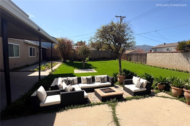 view of patio with a mountain view, an outdoor living space with a fire pit, and a fenced backyard