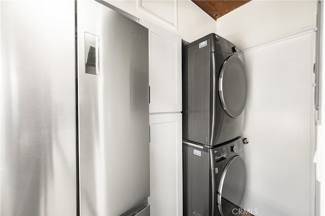 4040 Grand View Blvd Unit 35, Los Angeles, CA 90066 - laundry area with cabinet space and stacked washer / drying machine