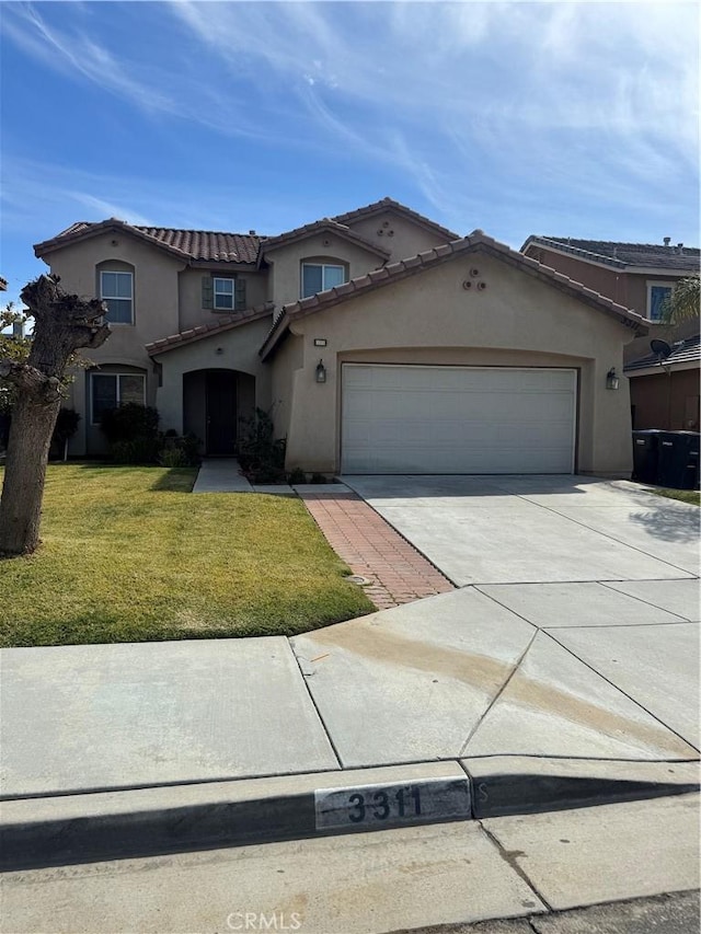 3311 Aster Ln, Perris, CA 92571 - mediterranean / spanish home featuring stucco siding, driveway, a garage, and a front yard