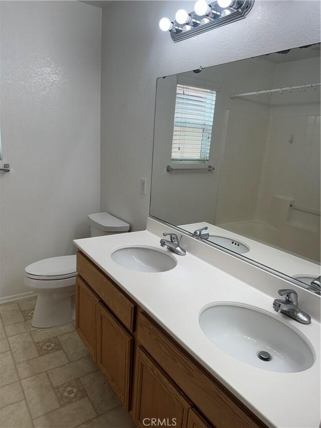 3311 Aster Ln, Perris, CA 92571 - bathroom with toilet, double vanity, and baseboards
