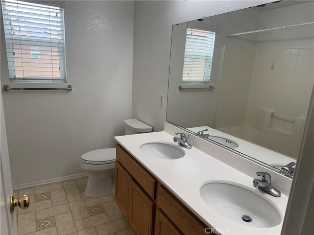 3311 Aster Ln, Perris, CA 92571 - full bathroom featuring toilet, baseboards, double vanity, and bathing tub / shower combination