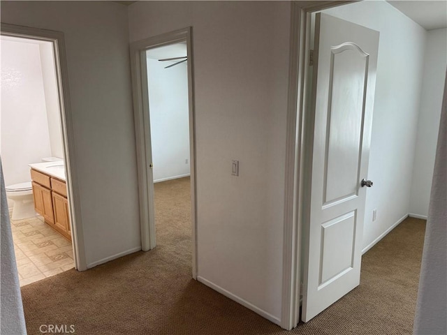 3311 Aster Ln, Perris, CA 92571 - corridor with light colored carpet and baseboards