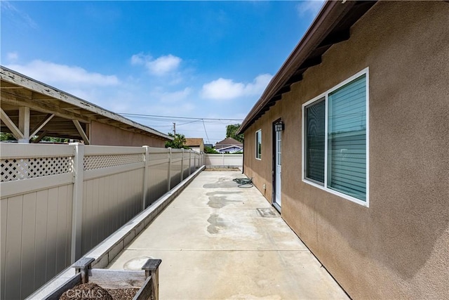 1143 Webster St, Redlands, CA 92374 - view of property exterior with fence, a patio area, and stucco siding