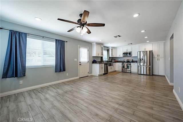 1143 Webster St, Redlands, CA 92374 - kitchen with visible vents, dark countertops, baseboards, stainless steel appliances, and recessed lighting