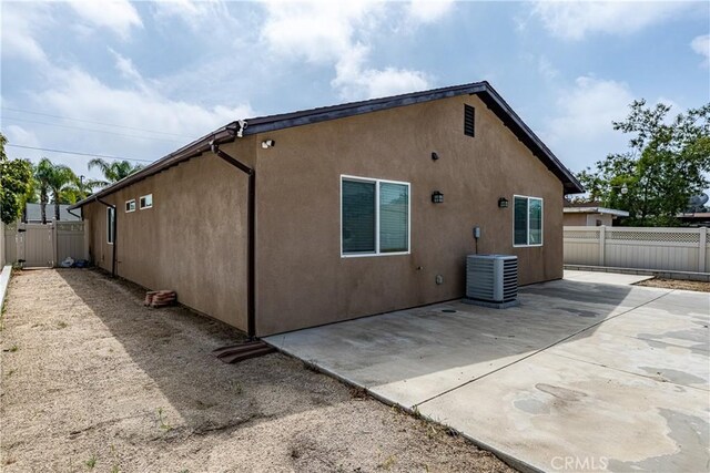 1143 Webster St, Redlands, CA 92374 - rear view of house featuring stucco siding, a patio, fence, and cooling unit
