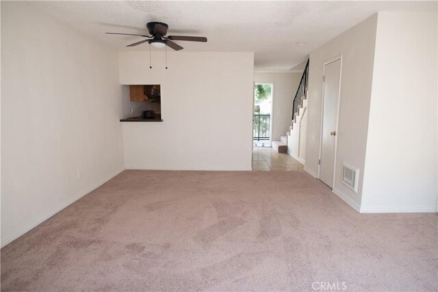 719 N Eucalyptus Ave Unit 19A, Inglewood, CA 90302 - unfurnished room with ceiling fan, carpet floors, baseboards, visible vents, and stairway