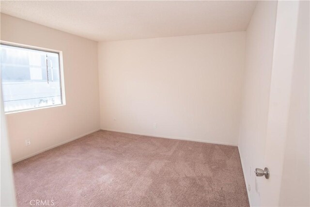 719 N Eucalyptus Ave Unit 19A, Inglewood, CA 90302 - unfurnished room featuring baseboards and carpet flooring
