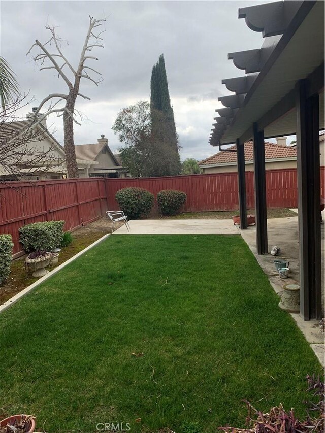 view of yard with a patio, a pergola, and a fenced backyard