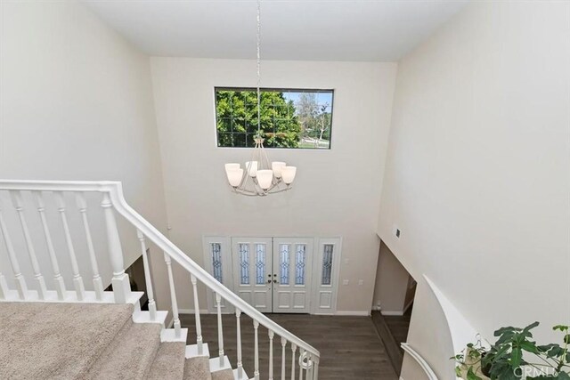 1618 Southport Dr, Riverside, CA 92506 - stairway with a chandelier, wood finished floors, and a high ceiling