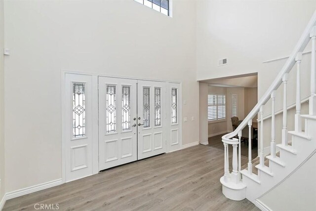 1618 Southport Dr, Riverside, CA 92506 - entrance foyer with a towering ceiling, stairway, wood finished floors, and baseboards