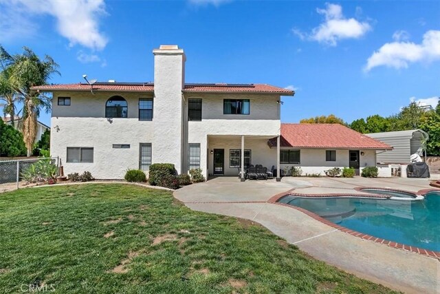 1618 Southport Dr, Riverside, CA 92506 - rear view of property featuring an in-ground hot tub, a patio, solar panels, a chimney, and an outdoor pool