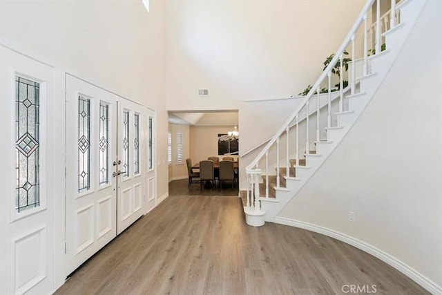 1618 Southport Dr, Riverside, CA 92506 - foyer with wood finished floors, stairs, a chandelier, baseboards, and a high ceiling