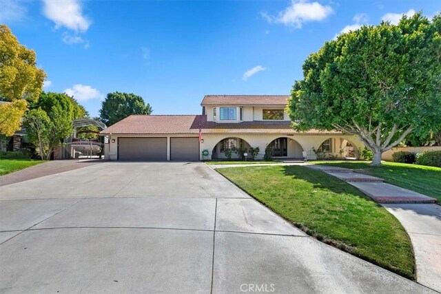 1618 Southport Dr, Riverside, CA 92506 - view of front of home featuring stucco siding, a garage, a front lawn, driveway, and a tiled roof