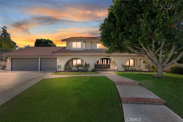 1618 Southport Dr, Riverside, CA 92506 - mediterranean / spanish house featuring stucco siding, a tile roof, driveway, an attached garage, and a yard