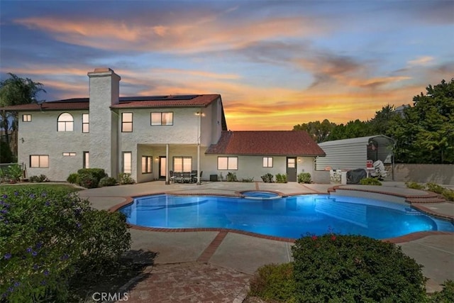 1618 Southport Dr, Riverside, CA 92506 - pool at dusk featuring a patio and a pool with connected hot tub