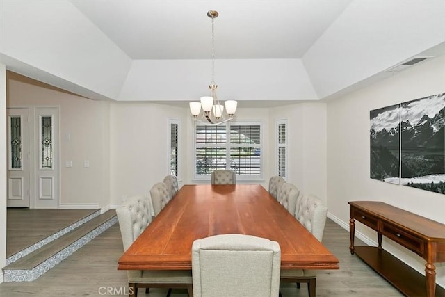 1618 Southport Dr, Riverside, CA 92506 - dining area with a raised ceiling, a chandelier, light wood-style floors, and baseboards