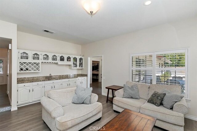 1618 Southport Dr, Riverside, CA 92506 - living room featuring bar with sink, dark wood-type flooring, baseboards, and recessed lighting