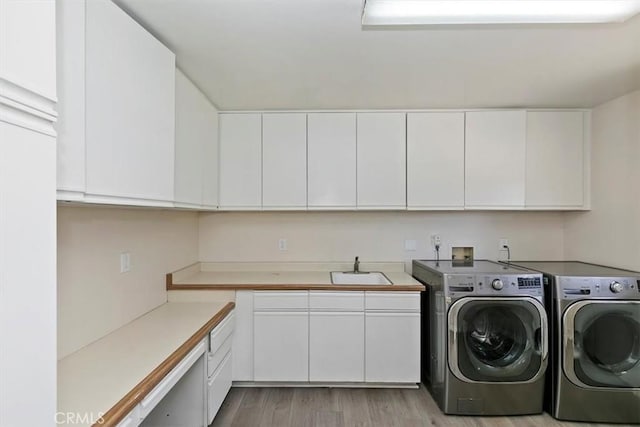1618 Southport Dr, Riverside, CA 92506 - laundry room with washer and dryer, cabinet space, and light wood-style flooring