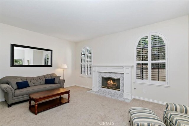 1618 Southport Dr, Riverside, CA 92506 - living area with healthy amount of natural light, carpet floors, and a high end fireplace