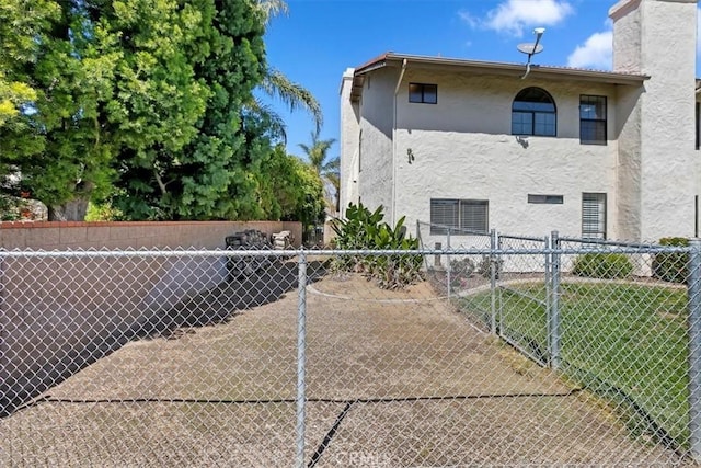 1618 Southport Dr, Riverside, CA 92506 - view of home's exterior with stucco siding and a chimney