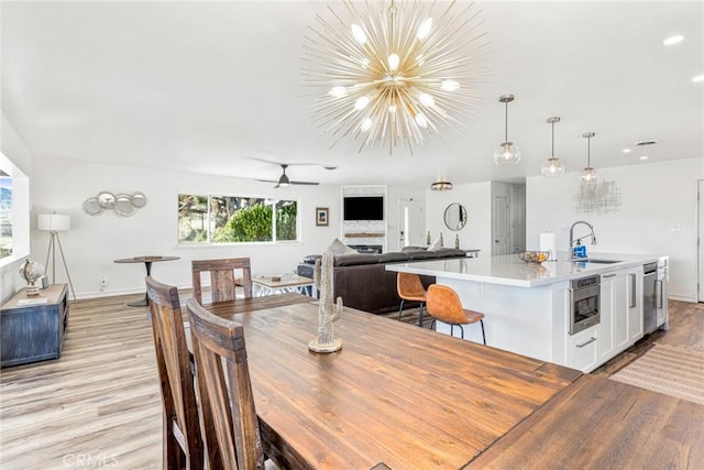 54660 Benecia Trl, Yucca Valley, CA 92284 - dining area featuring light wood finished floors, baseboards, a chandelier, a ceiling fan, and recessed lighting
