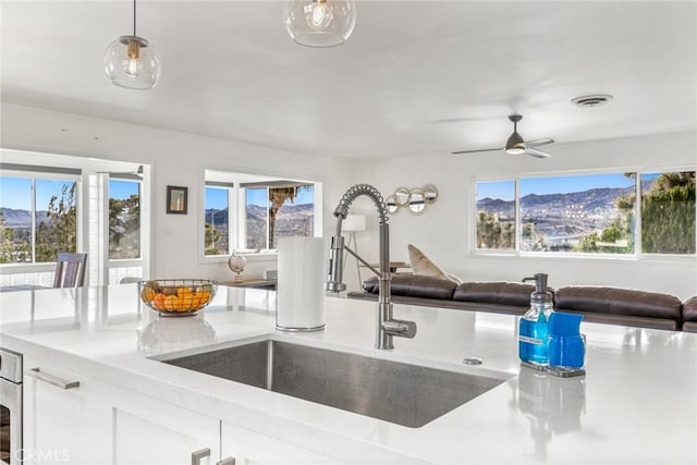 54660 Benecia Trl, Yucca Valley, CA 92284 - kitchen with a sink, open floor plan, plenty of natural light, and white cabinets