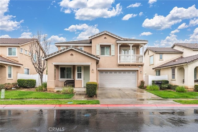 1677 Catania Dr, Riverside, CA 92507 - mediterranean / spanish house with driveway, stucco siding, an attached garage, fence, and a balcony