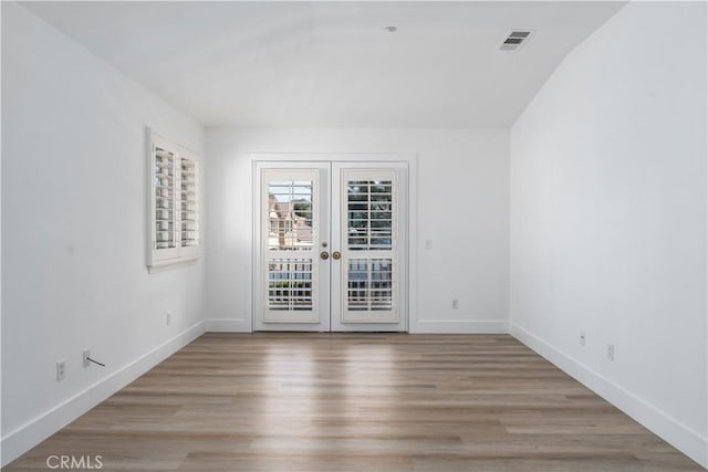 1677 Catania Dr, Riverside, CA 92507 - empty room featuring french doors, baseboards, light wood-style floors, and visible vents