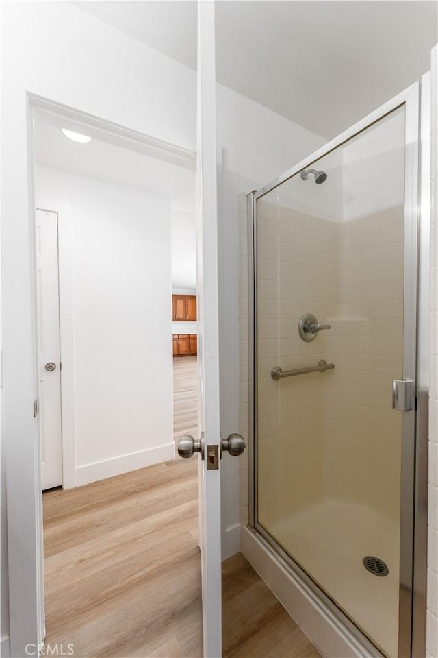 1677 Catania Dr, Riverside, CA 92507 - full bathroom featuring a shower stall, baseboards, and wood finished floors