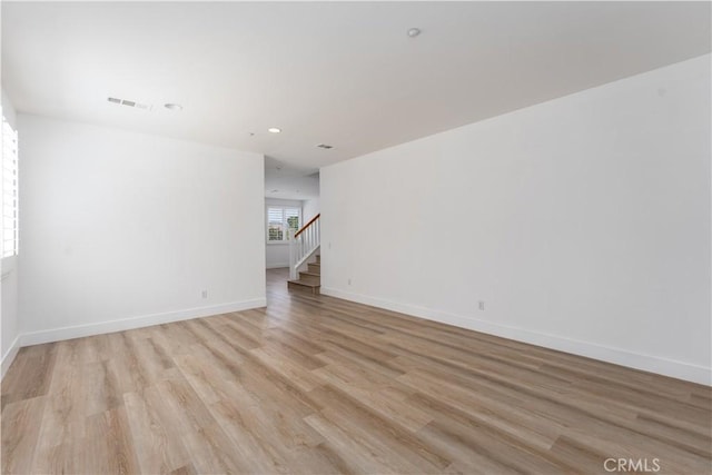 1677 Catania Dr, Riverside, CA 92507 - unfurnished room featuring stairway, light wood finished floors, baseboards, visible vents, and recessed lighting