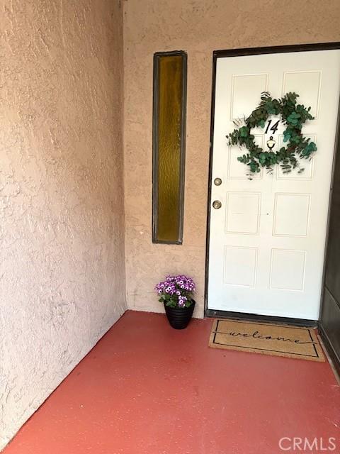 property entrance featuring stucco siding