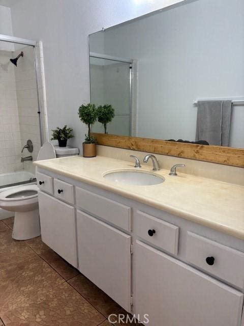 bathroom featuring toilet, tile patterned flooring, bathtub / shower combination, and vanity