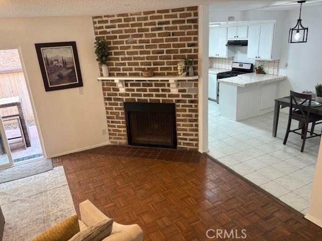 living area featuring baseboards and a fireplace