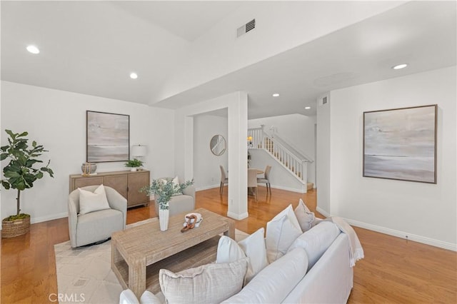 living room featuring recessed lighting, stairway, visible vents, and light wood finished floors