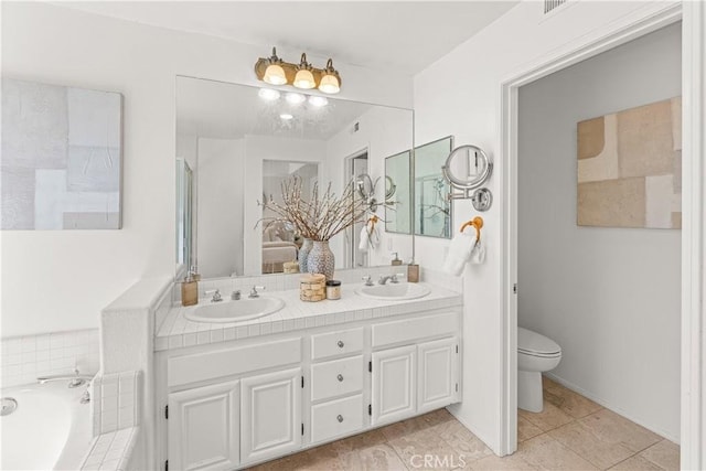 full bath featuring a bath, double vanity, toilet, and a sink