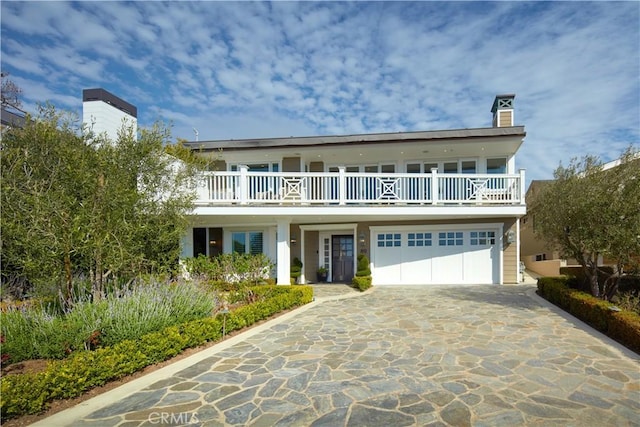 89 S La Senda Dr, Laguna Beach, CA 92651 - view of front property with an attached garage, a balcony, driveway, and a chimney