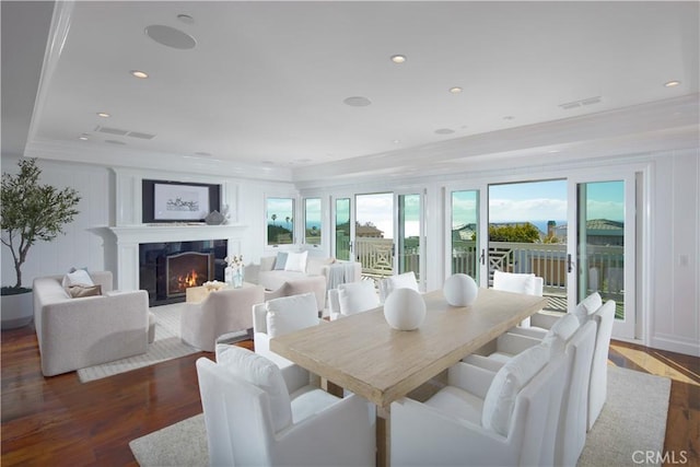 89 S La Senda Dr, Laguna Beach, CA 92651 - dining area featuring crown molding, wood finished floors, visible vents, and a fireplace