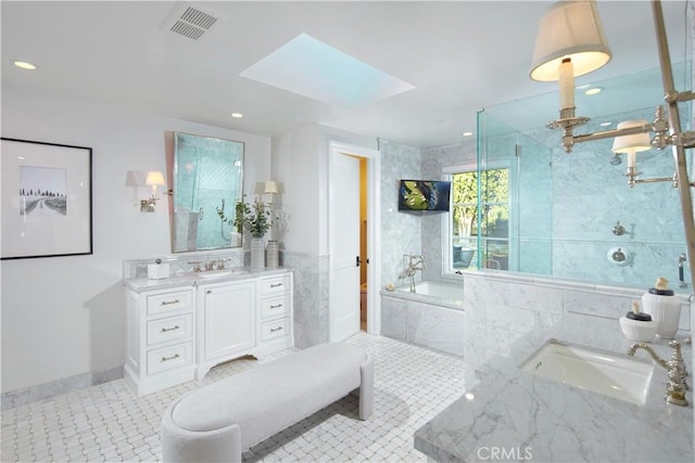 89 S La Senda Dr, Laguna Beach, CA 92651 - bathroom featuring vanity, tile patterned floors, a skylight, visible vents, and a garden tub